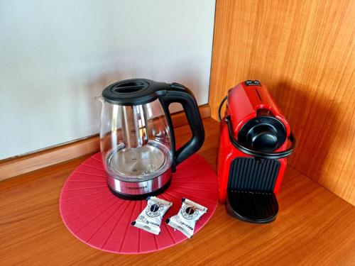 a red blender sitting on top of a table at Il Lago Incantato in Lonato del Garda