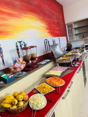 a kitchen with fruits and vegetables on a counter at Hotel Rosa da Ilha Guaruja - Perto do Mar com piscina in Guarujá