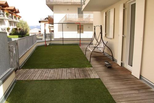 a balcony of a house with a tennis court at Appartamento nel Cuore della Val di Sole in Dimaro