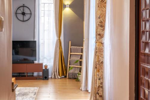 a living room with a sliding door and a television at Mi Casa Su Casa - Kyanja in Kampala