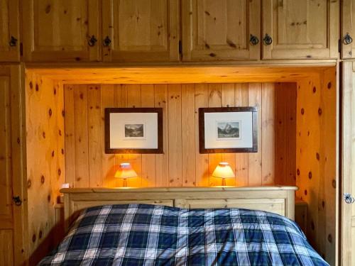 a bedroom with a bed and two pictures on the wall at Sankt Moritz Chesa Ruinatsch 50 in St. Moritz