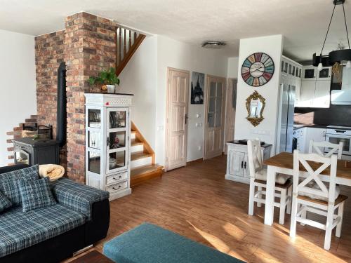a living room and kitchen with a couch and a table at Veselka in Dolní Bousov