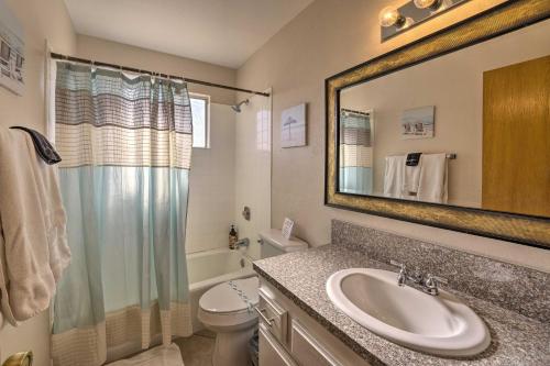 a bathroom with a sink and a toilet and a mirror at Lake Havasu Home with Heated Pool about 1 Mi to Water in Lake Havasu City