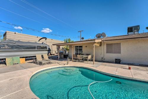 a swimming pool in front of a house with a train at Pool and boat parking 1 mi to lake in Lake Havasu City