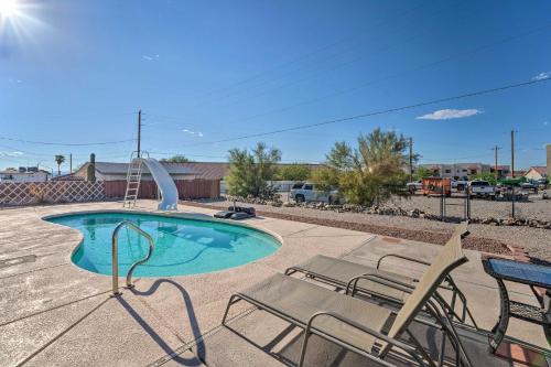 a swimming pool with two chairs and a slide at Pool and boat parking 1 mi to lake in Lake Havasu City