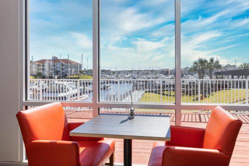 a table and chairs in front of a large window at Holiday Inn Express North Myrtle Beach - Little River by IHG in Little River