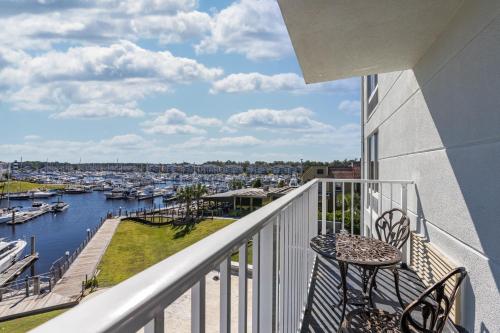 a balcony with chairs and a view of a marina at Holiday Inn Express North Myrtle Beach - Little River by IHG in Little River