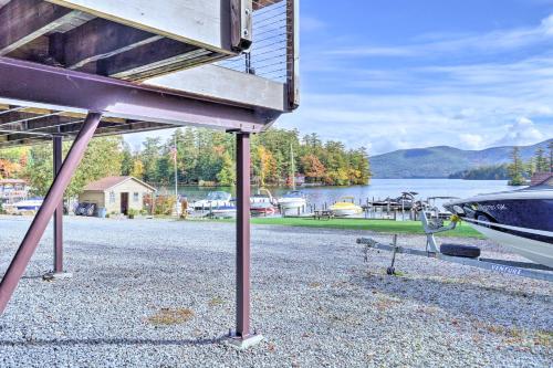 a boat on a gravel road next to a lake at Bolton Landing Suite with Deck, Lake George Access in Bolton Landing