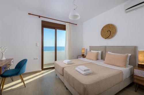 a bedroom with a bed and a desk and a window at Villa Corinna in Lachania