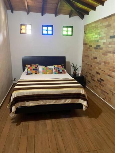 a bedroom with a large bed with pillows on it at Casa de campo Villa Tatiana- Mesa de Los Santos in Los Santos