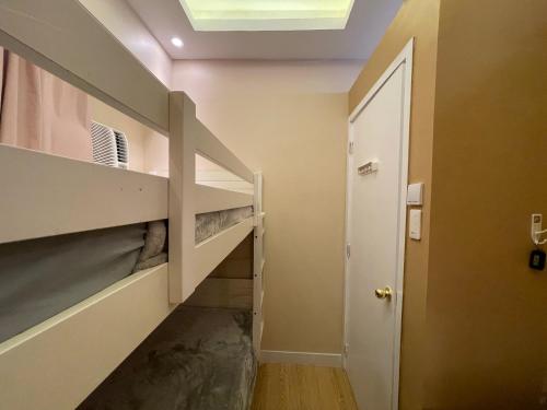 a hallway with a staircase in a house at SMDC Trees Residences Tower 1 - 2BR Newly Renovated Staycation in Manila
