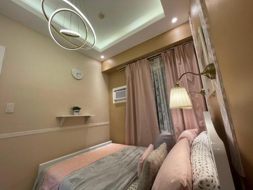 a small bedroom with a bed and a window at SMDC Trees Residences Tower 1 - 2BR Newly Renovated Staycation in Manila