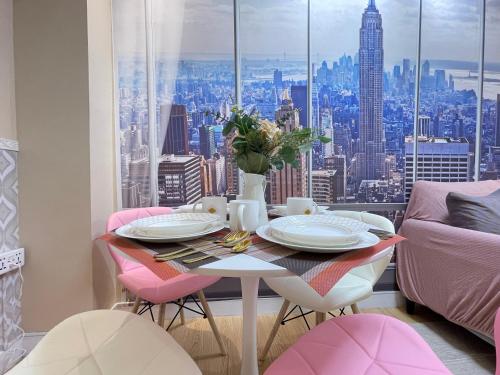 a dining room table with a view of the city at SMDC Trees Residences Tower 1 - 2BR Newly Renovated Staycation in Manila