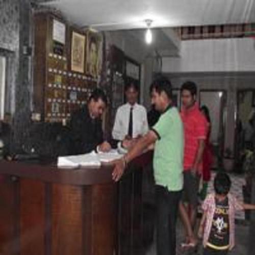 a group of people standing around a bar at Purohit Lodge B&B by StayApart in Gupta Kāshi