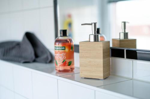 a bottle of cleaner sitting on a counter in a bathroom at FULL HOUSE Studios - R85 Apartments in Zwickau
