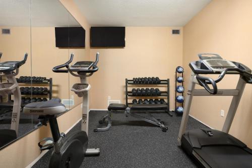 a gym with treadmills and exercise bikes in a room at Spark By Hilton Woodstock in Woodstock