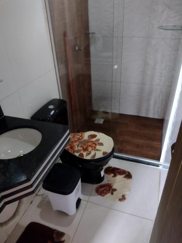 a bathroom with a toilet and a sink and a shower at Flat Raio de Sol - Taipu de Fora in Marau