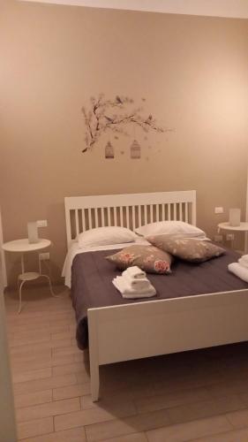 a bedroom with a bed with a tree on the wall at A casa di Marghe in La Spezia