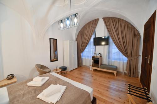 a bedroom with a bed and a living room at Althof Apartments in Sibiu