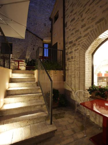 a staircase in a brick building with a table at Hotel Sorella Luna in Assisi