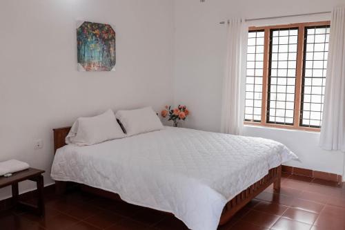 A bed or beds in a room at Wayal Wayanad Heritage villa