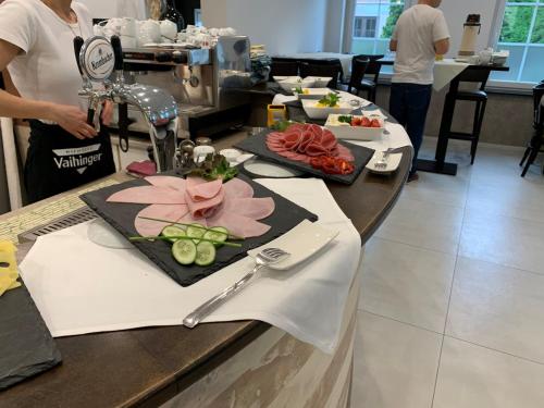 a table with food on it in a kitchen at Hotel Langhans in Abstatt