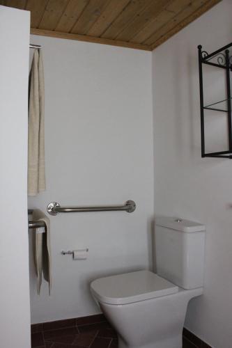 a bathroom with a toilet and a towel rack at Estalagem de Marvão in Marvão