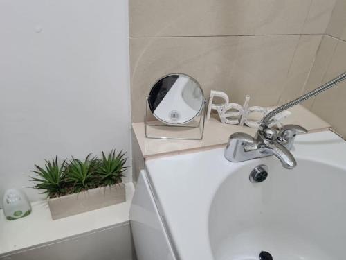 a bathroom with a sink and a mirror on a counter at TimeChance Property Homz - Norton Road 1 Bed Apartment in Stockton-on-Tees