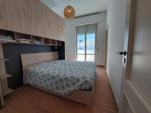 ein Schlafzimmer mit einem Bett in einem Zimmer mit einem Fenster in der Unterkunft La Casa sul Mare in Francavilla al Mare