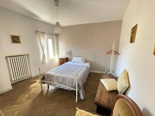 a bedroom with a bed and a table and a window at Casa Garibaldi 41 in Perugia