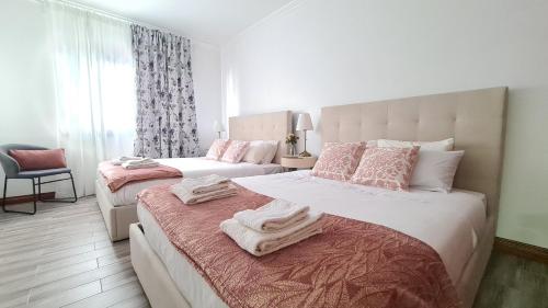a bedroom with two beds with towels on them at Santa Luzia Apt 59 A in Ribeira Grande