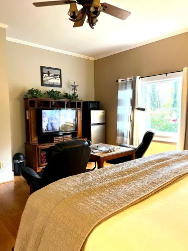 a bedroom with a bed and a flat screen tv at Grafton Lodge in Lake Lure