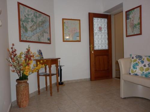 a living room with a couch and a table and a door at Manor Villa in Hévíz