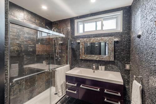 a bathroom with a sink and a shower at Spacious Home with Garden & Pool in Northridge