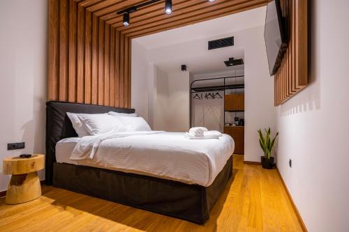 a bedroom with a large bed with a black headboard at Snob Athens in Athens
