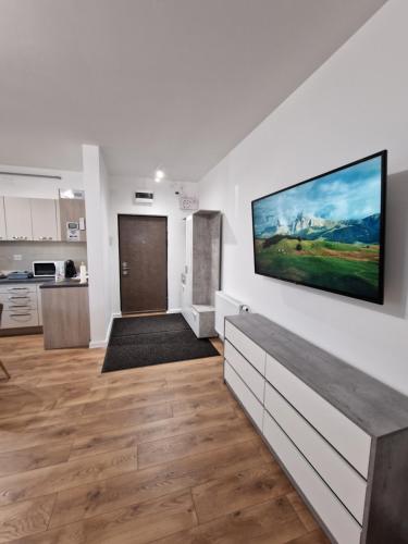 a living room with a large painting on the wall at Vic Apartament in Drobeta-Turnu Severin