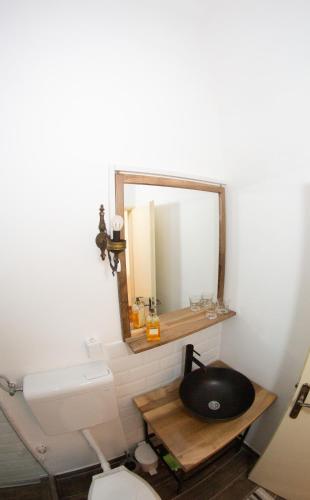 a bathroom with a sink and a mirror at Apartments & Room - Korzo in Sombor