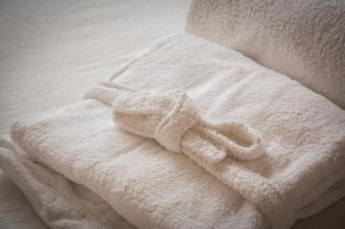 a white towel sitting on top of a bed at Dimora Sinibaldi in Palermo