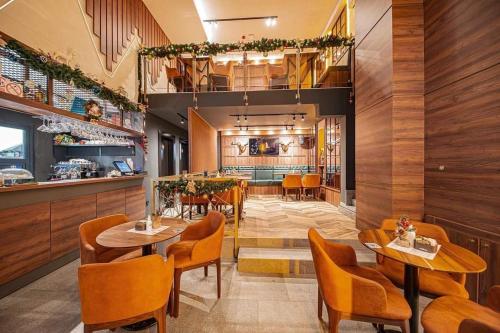 a restaurant with tables and chairs and a bar at Modern mountain - Crown apartment in Kolašin