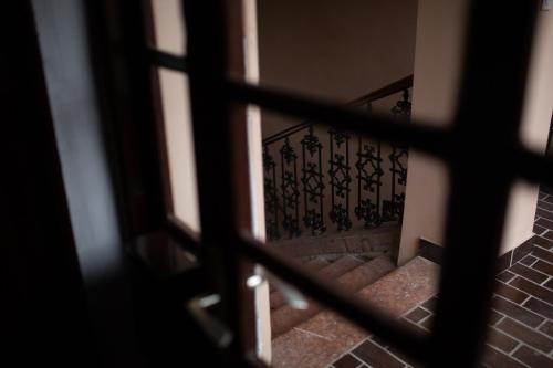 a view of a staircase through a window at Apartments & Room - Korzo in Sombor