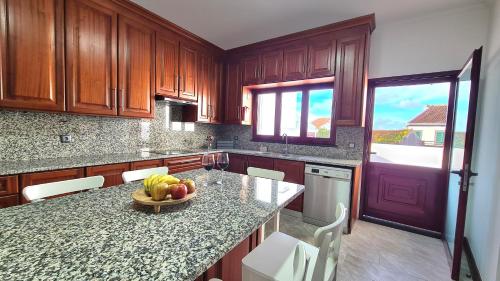 a kitchen with a bowl of fruit on a counter at Santa Luzia Apt I in Ribeira Grande