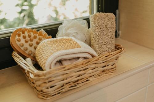 a basket filled with towels sitting on a counter at Forest House in Palić