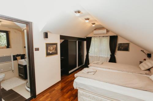 a bedroom with a bed and a window at Forest House in Palić