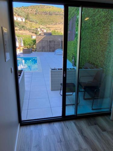 a view of a patio through a sliding glass door at DouroXisto in Peso da Régua