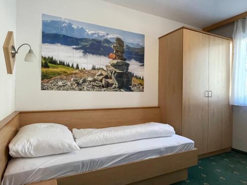 a bedroom with a bed with a picture on the wall at Apartment Heijerhof - Top 4 in Wagrain