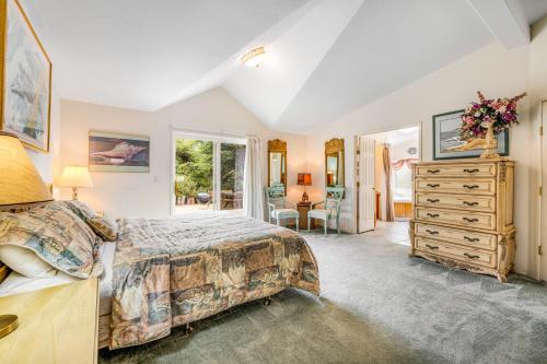 a bedroom with a bed and a dresser at Mendocino Dunes - Sandrahla in Fort Bragg
