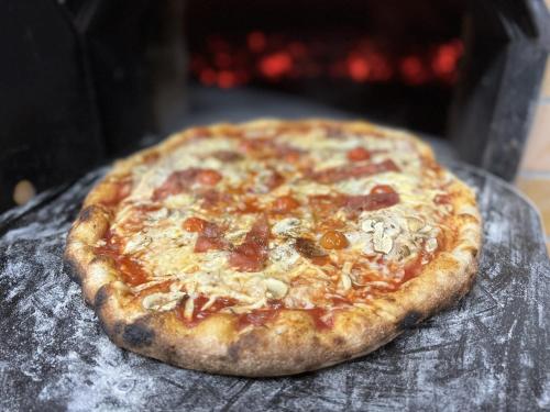 a pizza sitting on top of a table at Villa Mukinja - Wellness & Spa in Plitvička Jezera