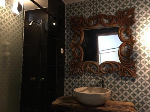 a bathroom with a sink and a mirror at Grand Mulia Sakinah Resort & Outbond in Pasuruan