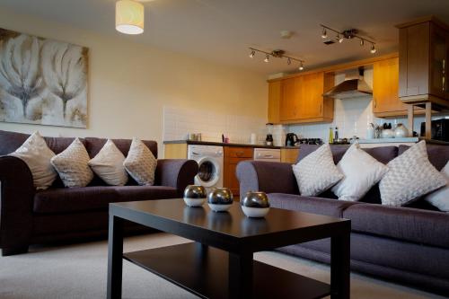 a living room with couches and a coffee table at The Lindley Suite – Simple2let Serviced Apartments in Huddersfield