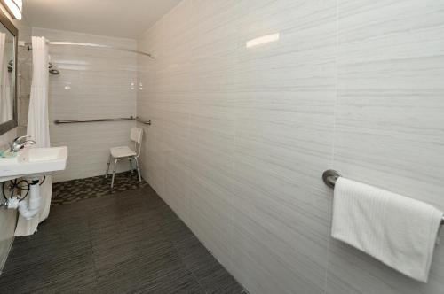 a white bathroom with a sink and a toilet at Americas Best Value Inn at Central Valley-Woodbury in Central Valley